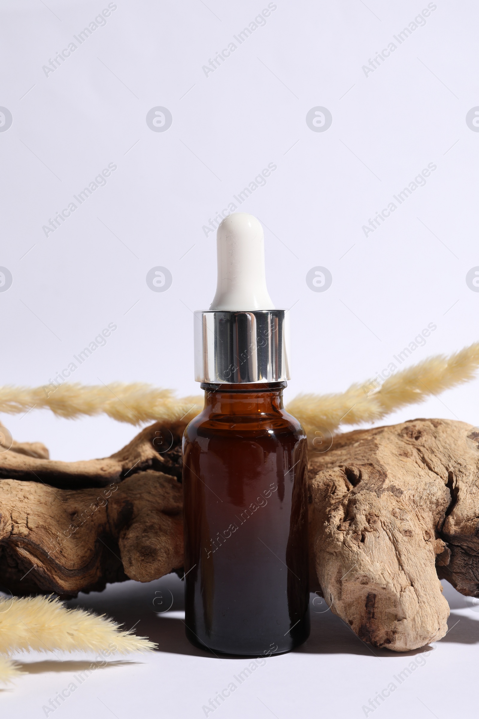 Photo of Composition with bottle of cosmetic serum on white background