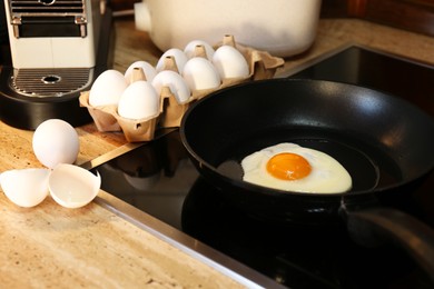 Photo of Cooking egg in frying pan for breakfast