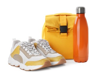 Stylish shoes, backpack and bottle of water on white background