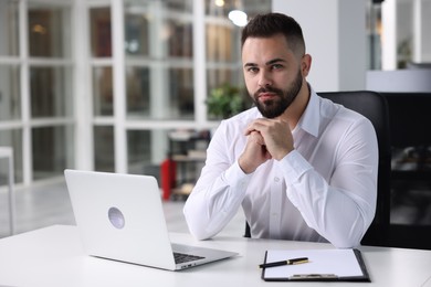 Photo of Portrait of handsome man at table in office. Lawyer, businessman, accountant or manager