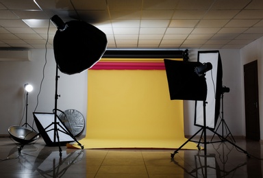 Photo of Interior of modern photo studio with professional lighting equipment