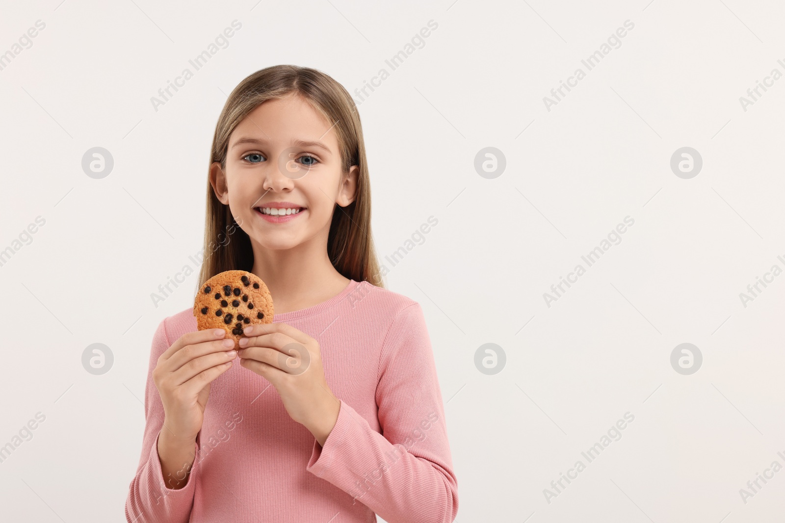 Photo of Cute girl with chocolate chip cookie on white background. Space for text
