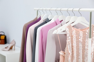 Rack with stylish clothes in boutique, closeup