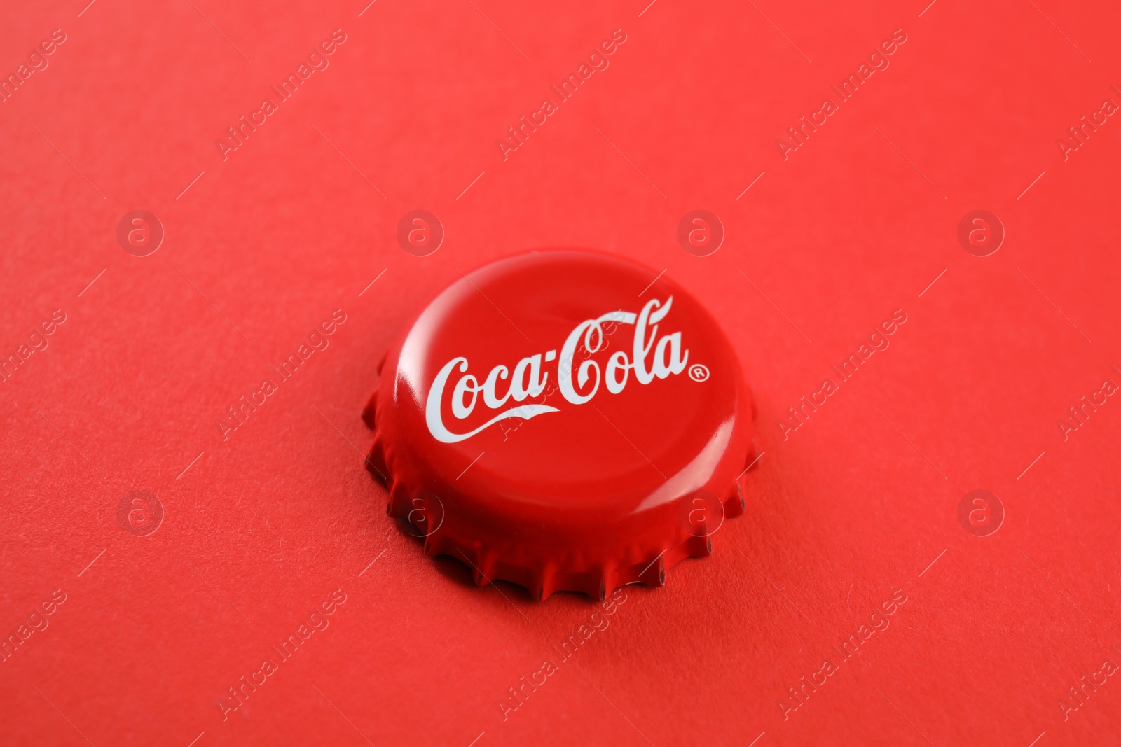 Photo of MYKOLAIV, UKRAINE - NOVEMBER 15, 2018: Coca Cola lid on color background