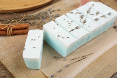 Photo of Natural handmade soap with lavender on wooden table