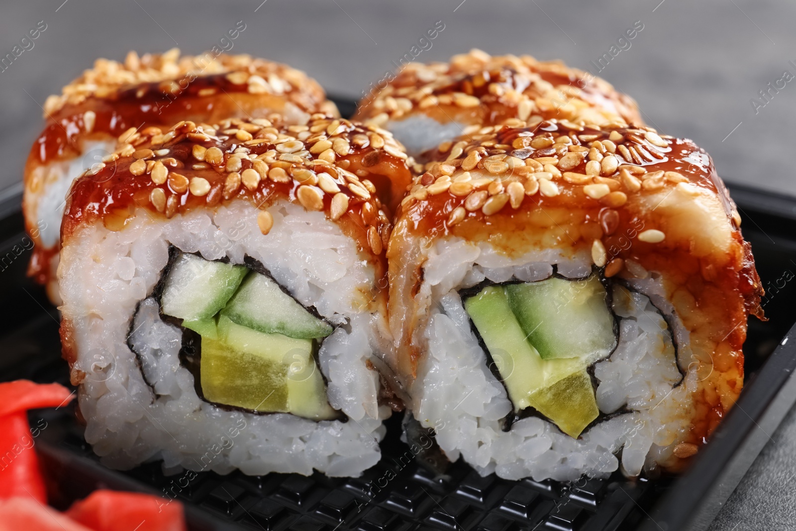 Photo of Fresh tasty sushi rolls, closeup. Food delivery service