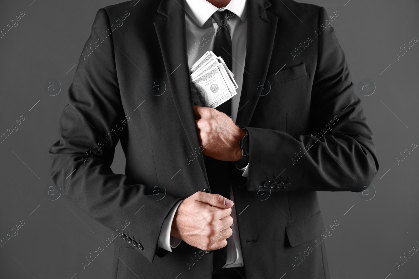 Photo of Man with bribe money on dark background, closeup