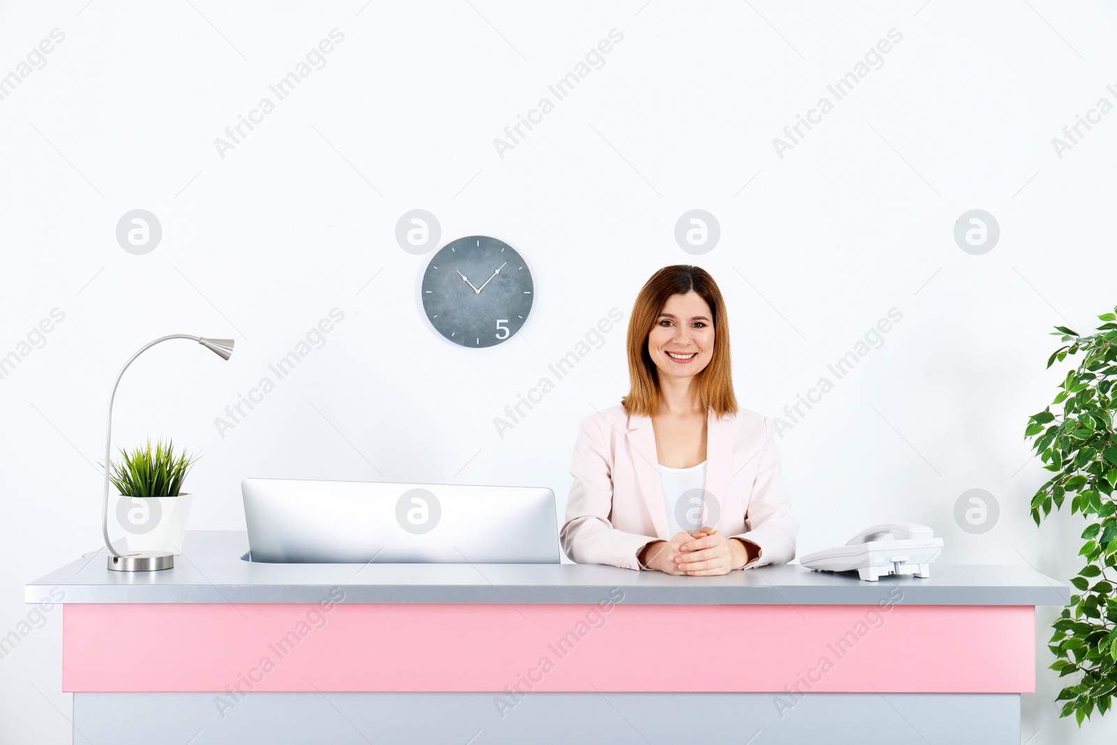 Photo of Beautiful woman at reception desk in beauty salon