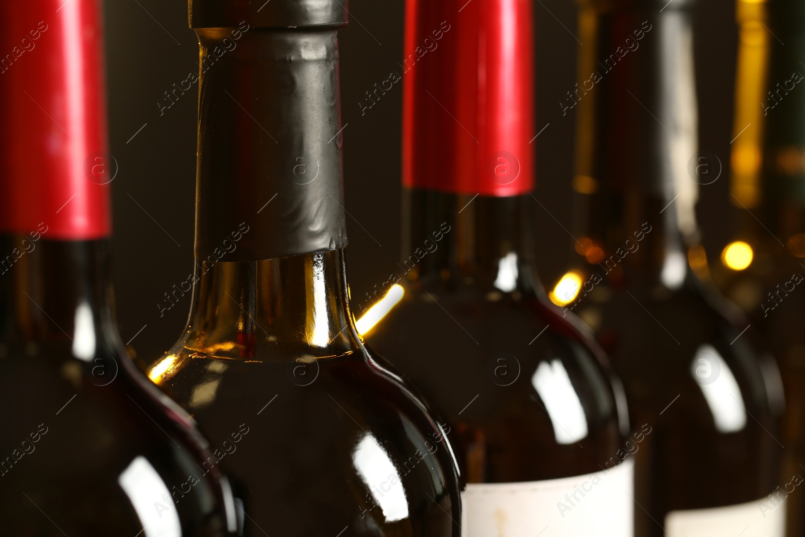 Photo of Bottles of different wines, closeup. Expensive collection