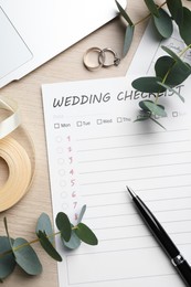 Photo of Flat lay composition with Wedding Checklist on white wooden table