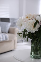 Bouquet of beautiful peony flowers on table indoors