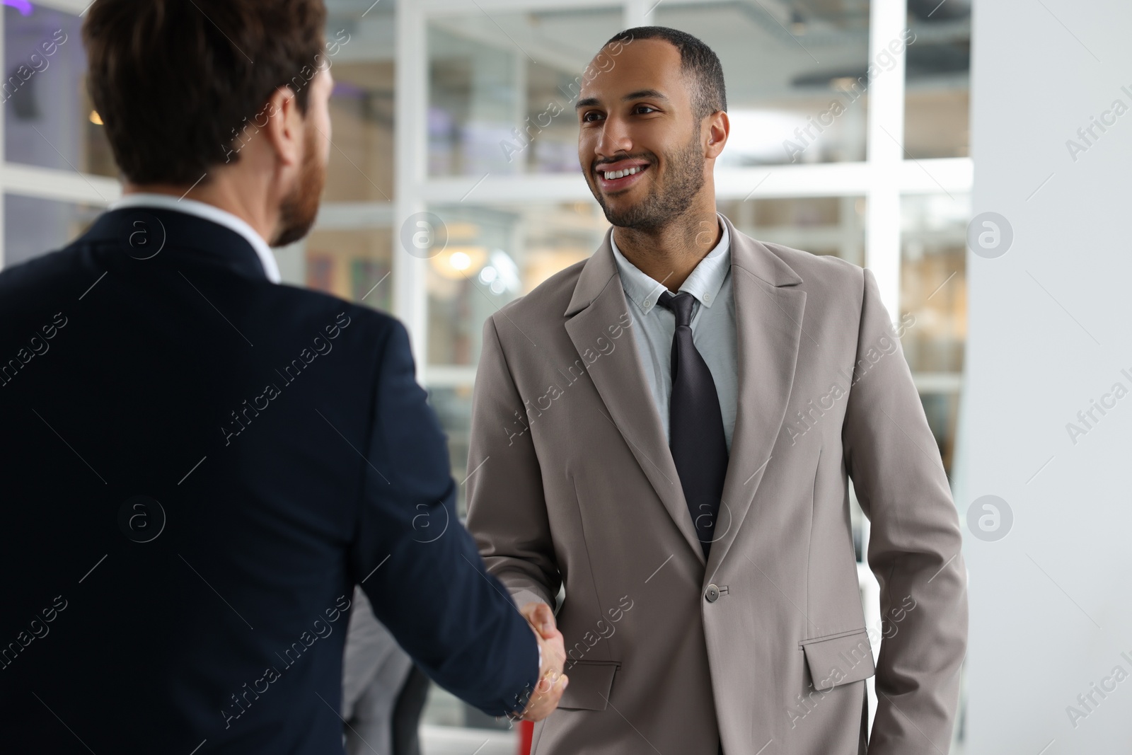 Photo of Lawyer shaking hands with client in office