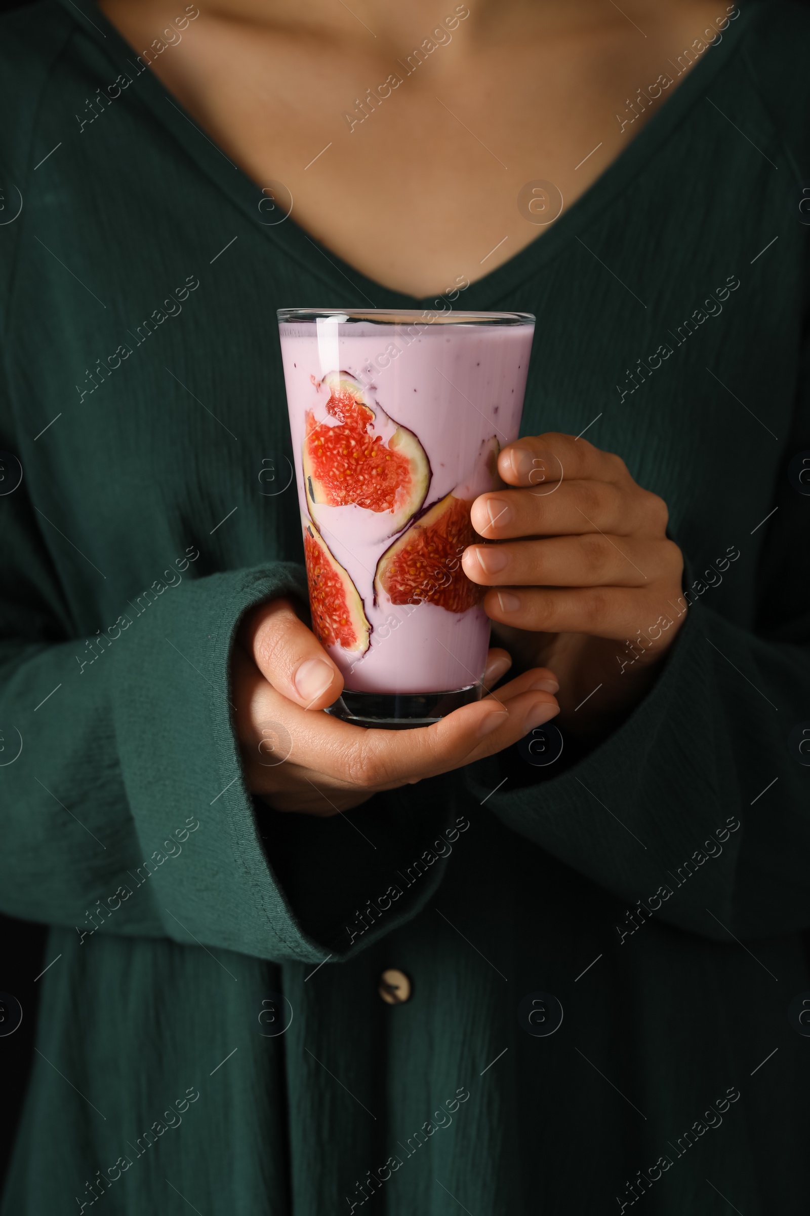 Photo of Woman holding fresh fig smoothie, closeup view