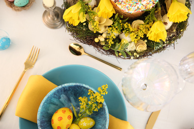 Photo of Festive Easter table setting with beautiful floral decor and eggs, flat lay