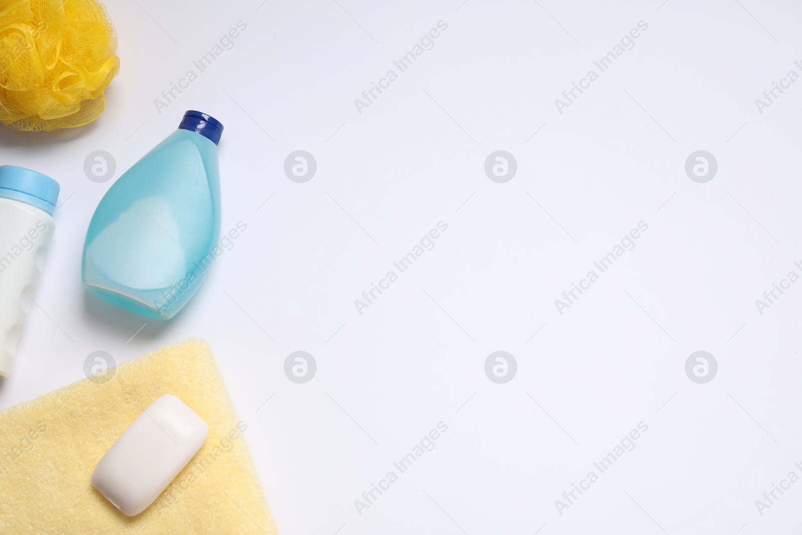 Photo of Baby cosmetic products, sponge and towel on white background, flat lay. Space for text