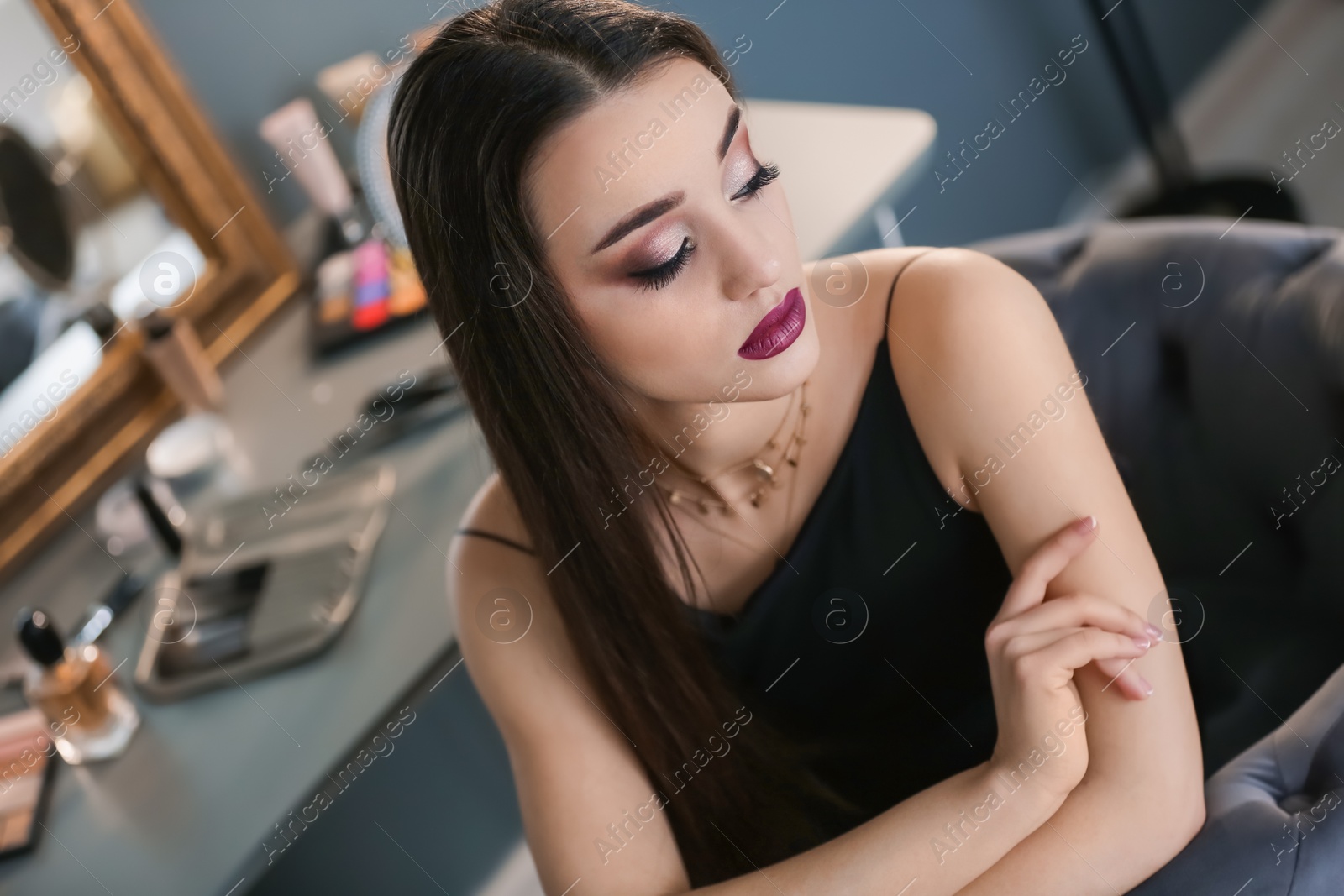 Photo of Portrait of beautiful woman with bright makeup indoors