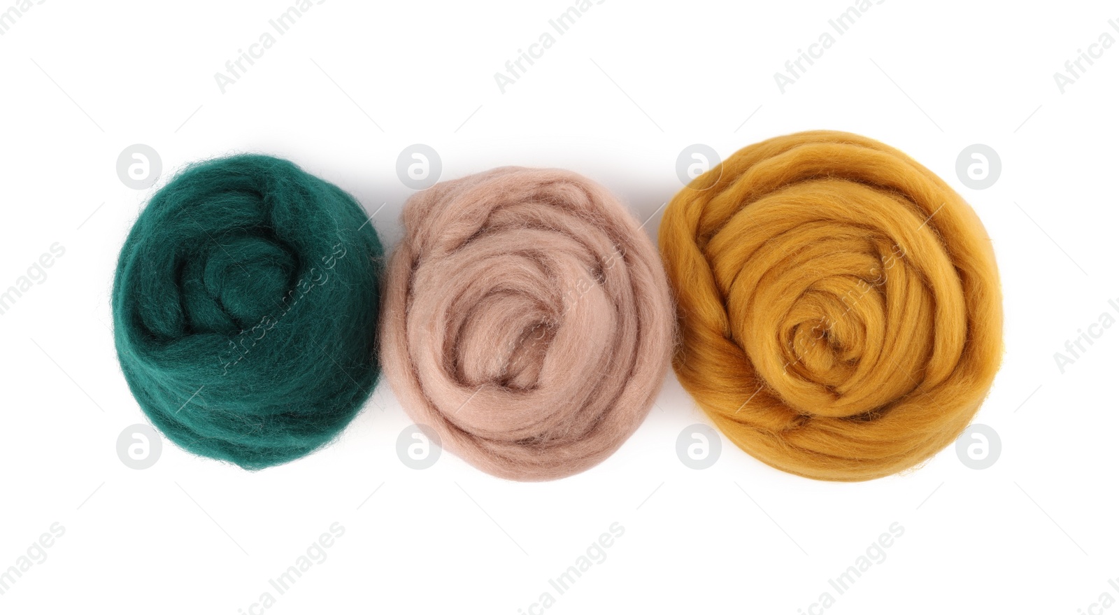 Photo of Green, beige and yellow felting wool isolated on white, top view