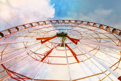 Image of Beautiful large Ferris wheel outdoors, low angle view