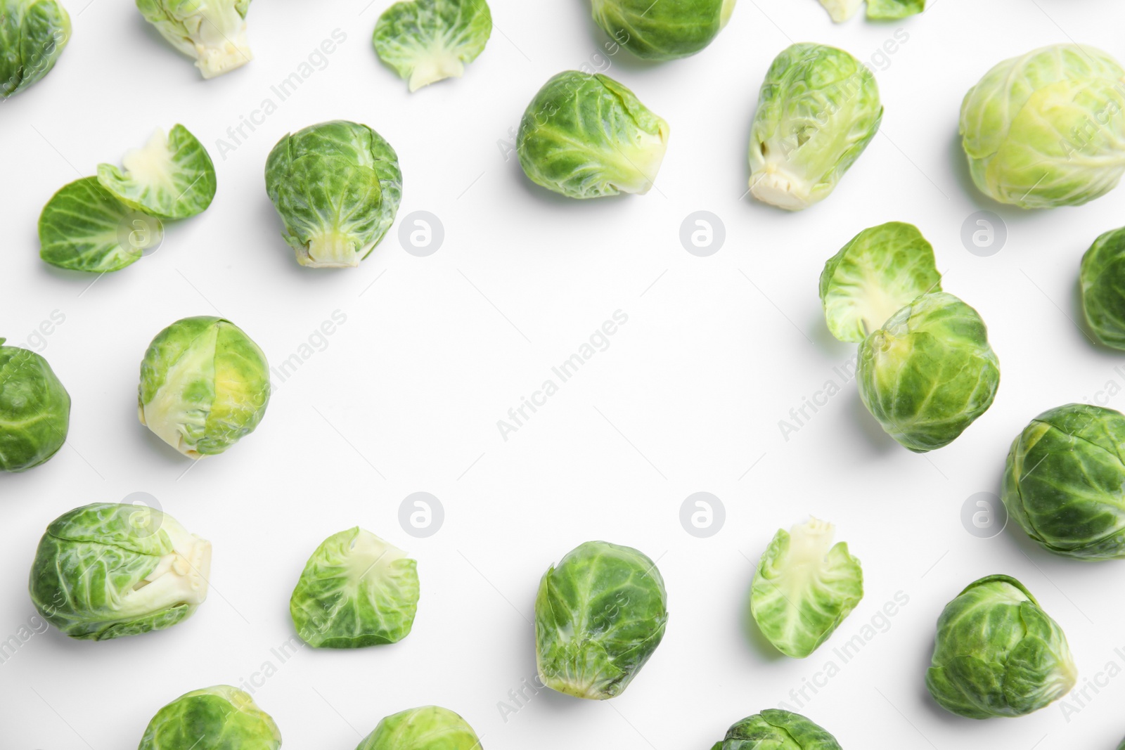 Photo of Fresh Brussels sprouts on white background, top view. Space for text