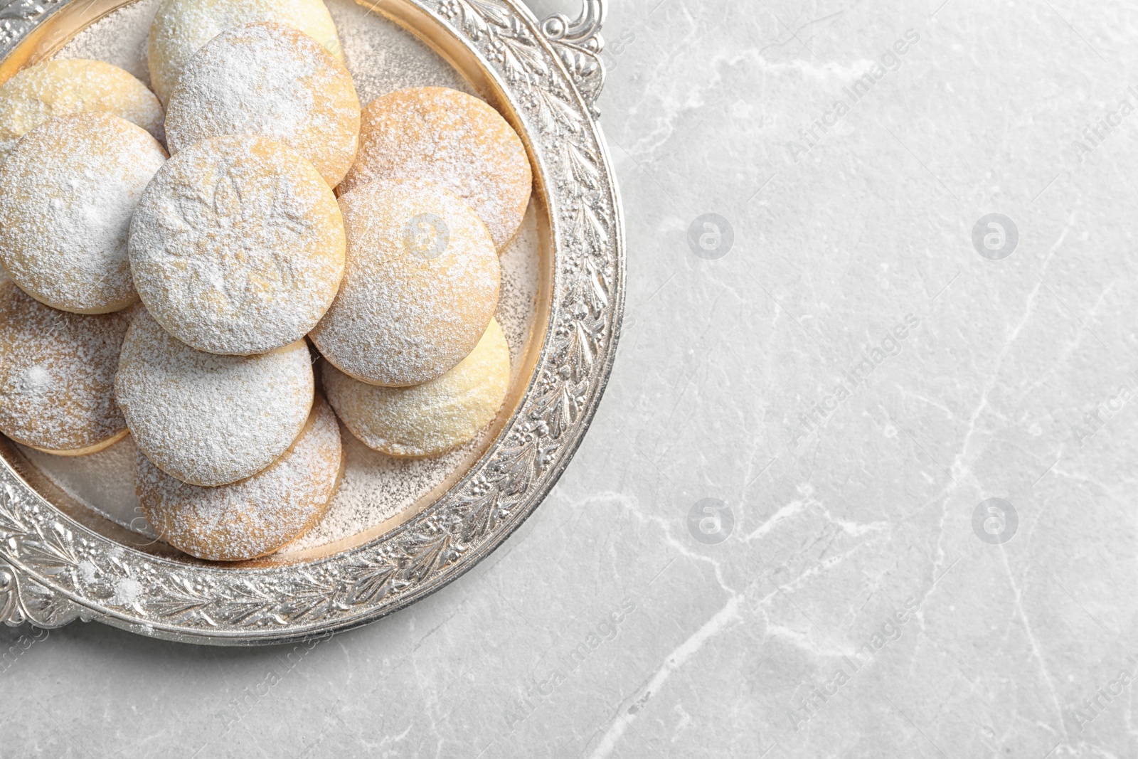 Photo of Dish of traditional cookies for Islamic holidays on table, top view with space for text. Eid Mubarak