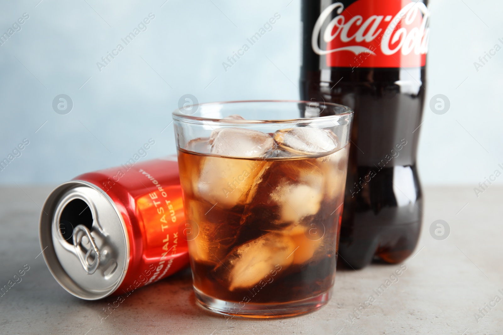 Photo of MYKOLAIV, UKRAINE - NOVEMBER 15, 2018: Bottle, glass and can with Coca Cola on table, closeup