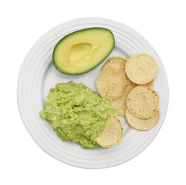 Photo of Delicious guacamole, avocado and chips on white background, top view
