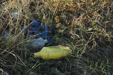 Photo of Different plastic garbage outdoors. Environmental pollution concept