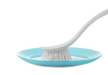 Photo of Cleaning dish with brush on white background