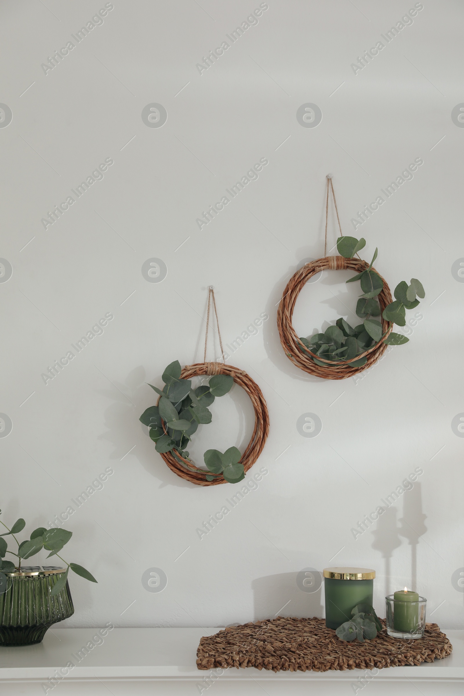 Photo of Beautiful eucalyptus decor on white wall in room. Interior element