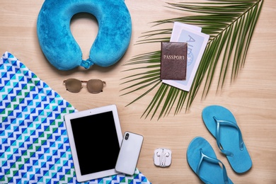 Photo of Flat lay composition with tablet, smartphone and beach objects on wooden background