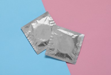 Condom packages on color background, flat lay. Safe sex