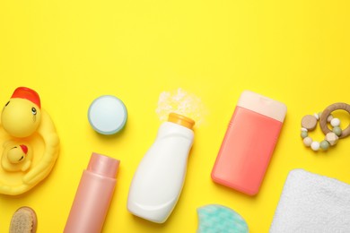 Photo of Flat lay composition with baby cosmetic products on yellow background