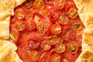 Tasty tomato galette (Caprese galette) as background, top view