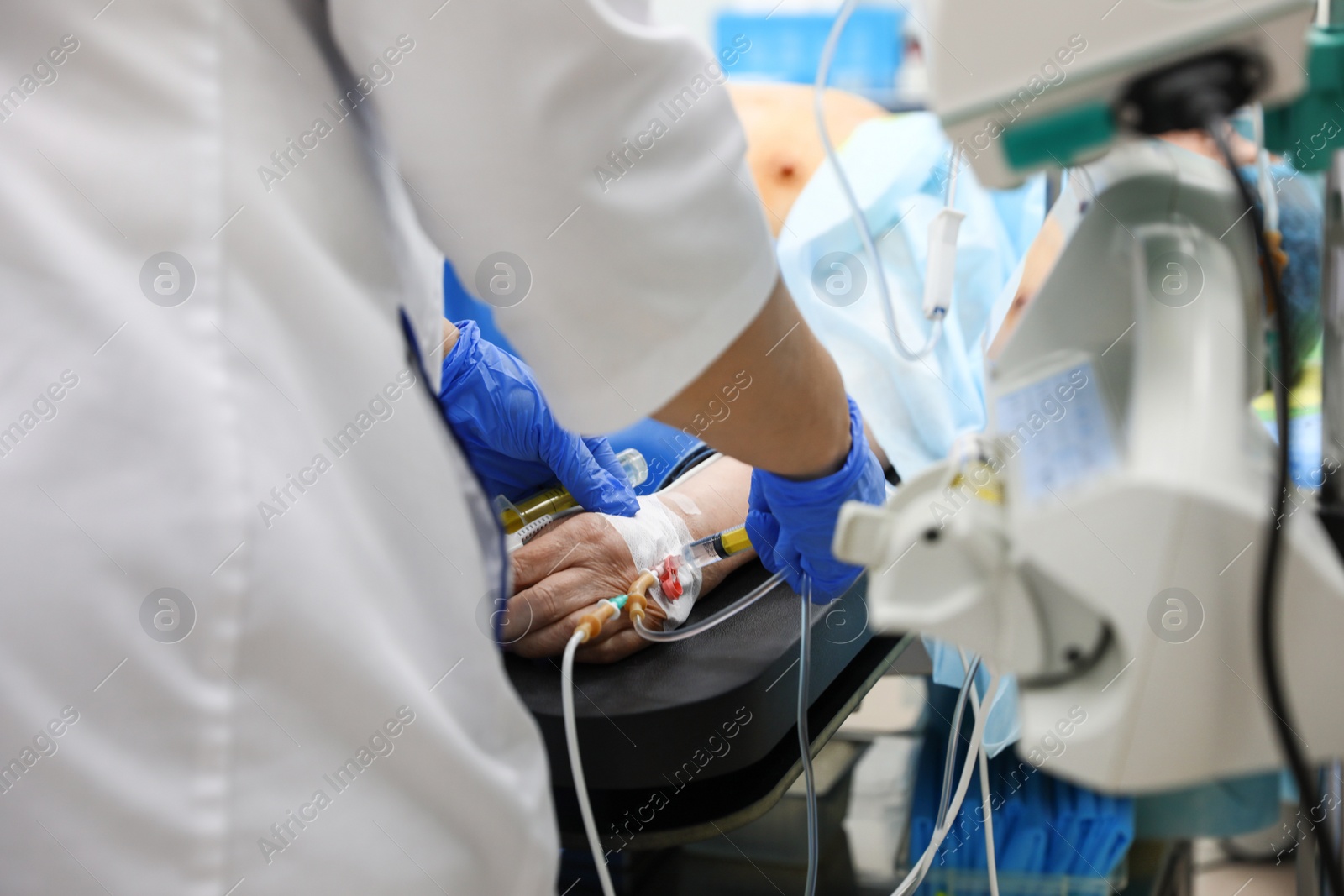 Photo of Doctor preparing patient for surgery in operating room, closeup