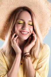 Photo of Beautiful young woman in hat, closeup. Summer fashion