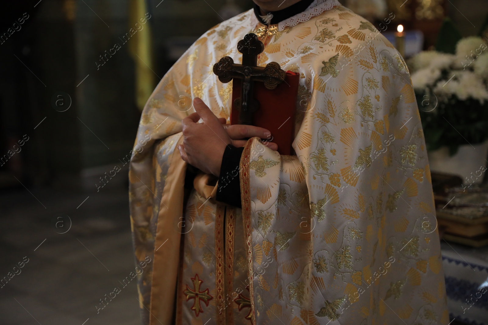 Photo of Stryi, Ukraine - September 11, 2022: Priest conducting baptism ceremony near altar in Assumption of Blessed Virgin Mary cathedral, closeup