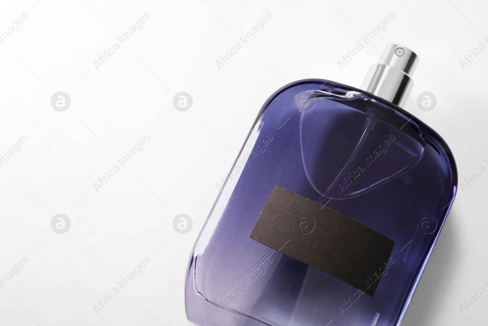 Photo of Luxury men`s perfume in bottle on white background, top view. Space for text