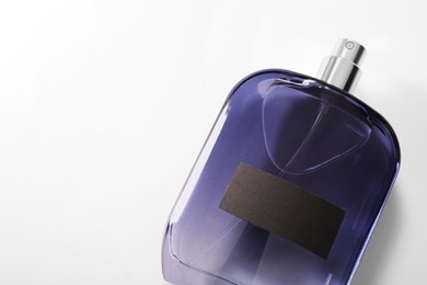 Luxury men`s perfume in bottle on white background, top view. Space for text