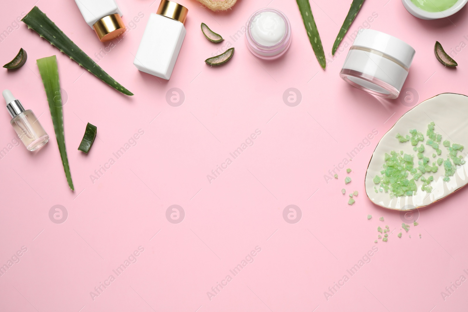 Photo of Flat lay composition with aloe vera and cosmetic products on pink background. Space for text