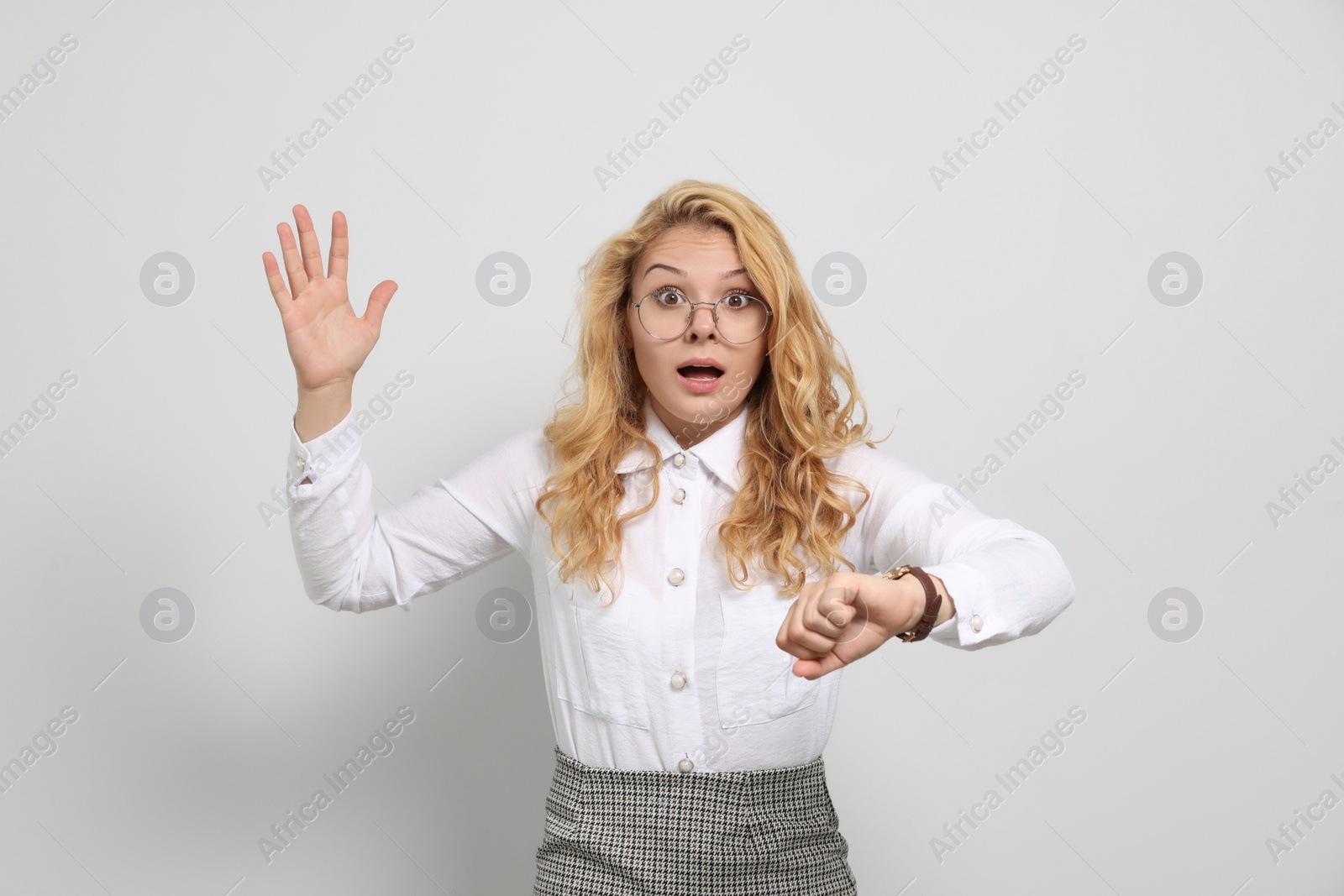 Photo of Emotional businesswoman in turmoil over being late on white background