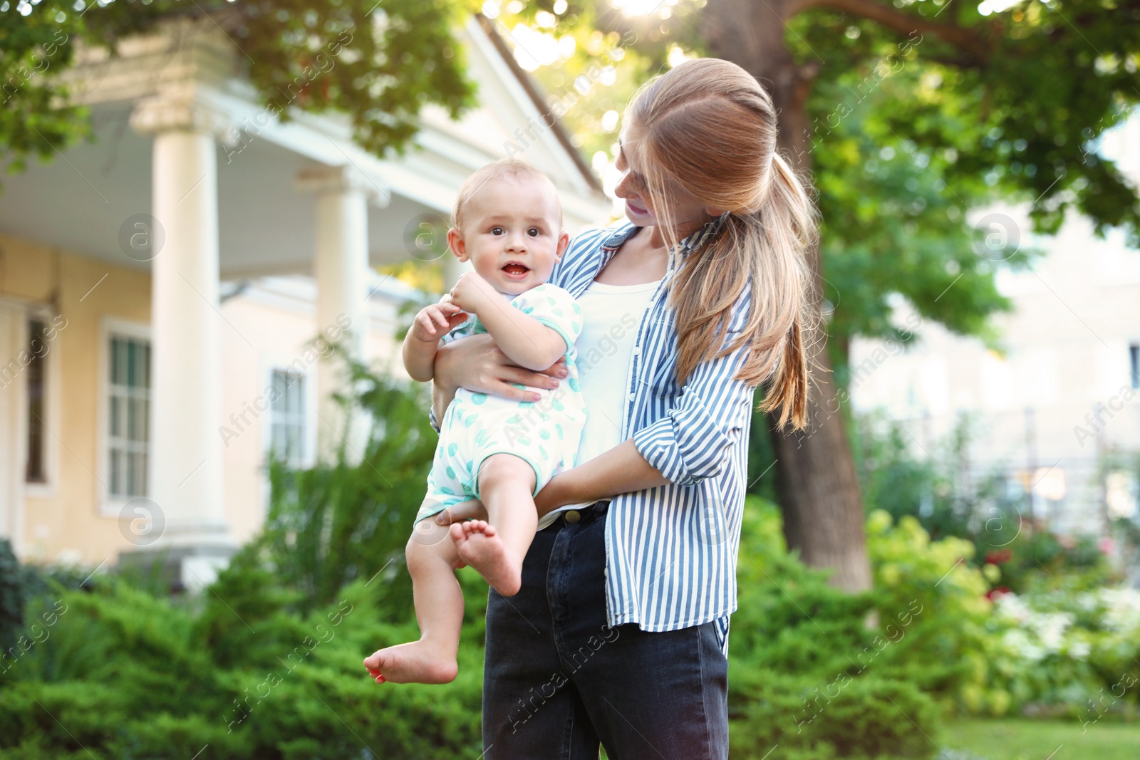 Photo of Teen nanny with cute baby outdoors on sunny day