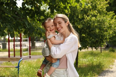 Photo of Happy mother hugging her daughter in park