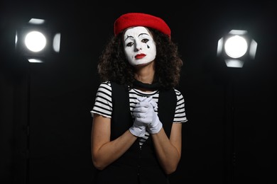 Young woman in mime costume performing on stage