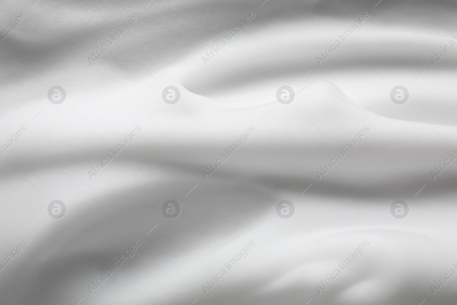 Photo of Texture of white shaving foam as background, top view