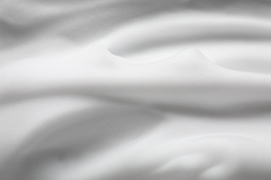 Photo of Texture of white shaving foam as background, top view