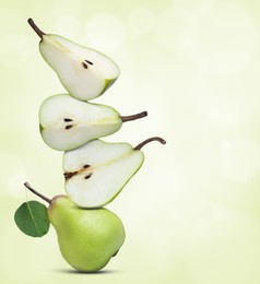 Image of Cut and whole fresh ripe pears on light green gradient background, space for text