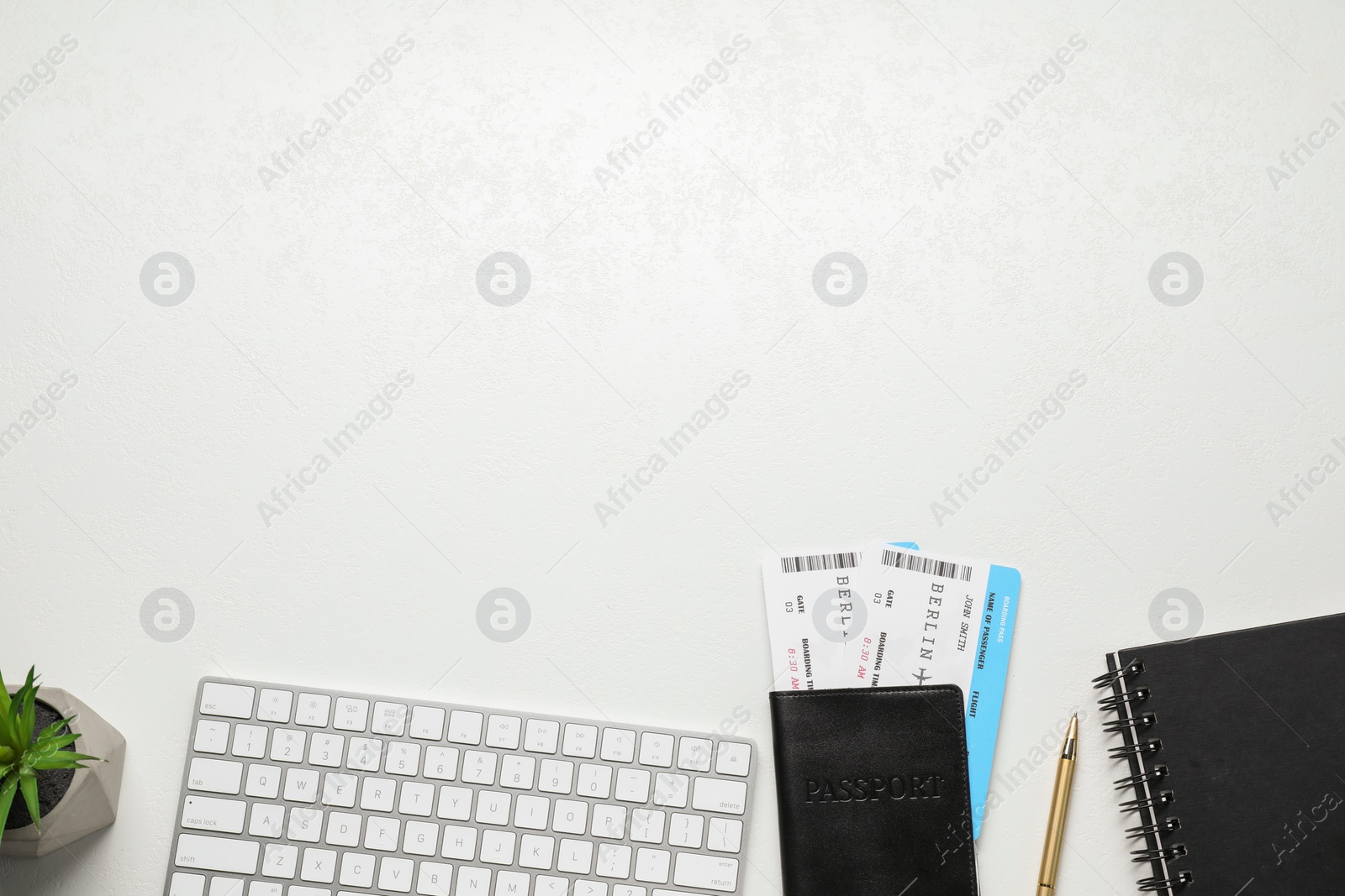 Photo of Flat lay composition with tickets, passport and keyboard on white table, space for text. Business trip