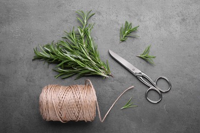 Photo of Sprigsrosemary, scissors and twine on black background, flat lay