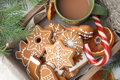 Photo of Crate with tasty homemade Christmas cookies and cup of coffee, closeup