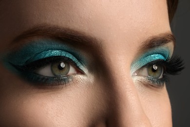 Photo of Young woman with evening makeup, closeup. Eye shadow product